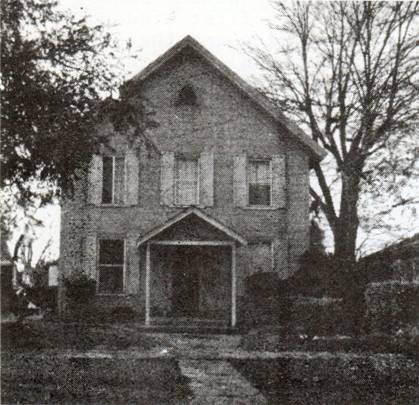 Black and white image of small wood church building