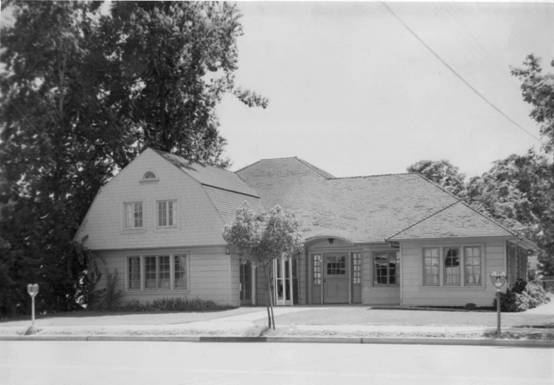 Black and white image of large house with 2nd story