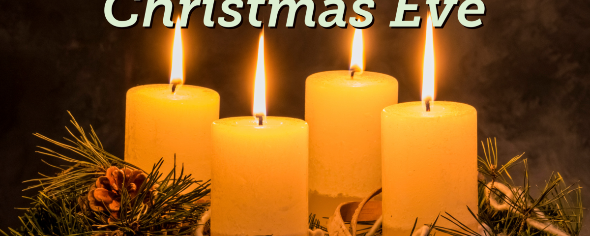 four lit white pillar candles in a pine wreath with the text "Christmas Eve"