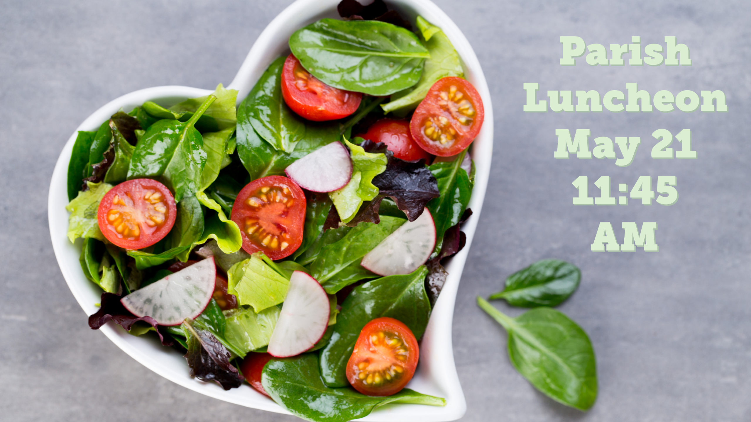 areal shot of a heart-shaped bowl of salad with the text "Parish Luncheon May 21 11:45 AM"